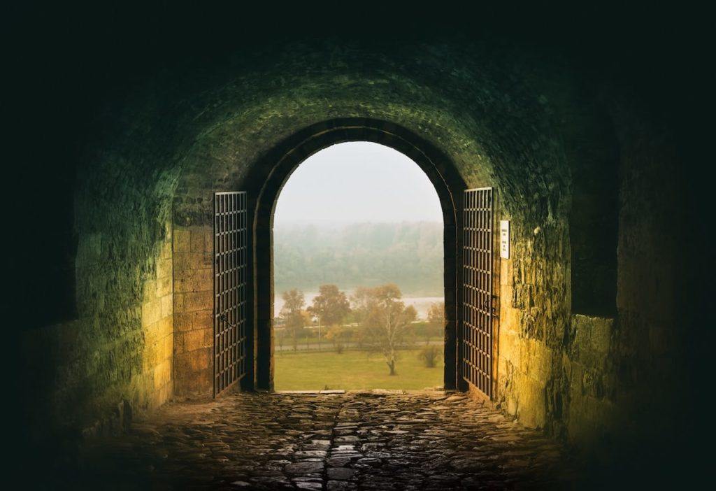 Looking out of a tunnel with an open gate